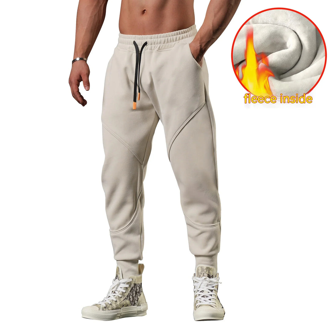 Man wearing beige fleece-lined jogger pants with drawstring waist and high-top sneakers