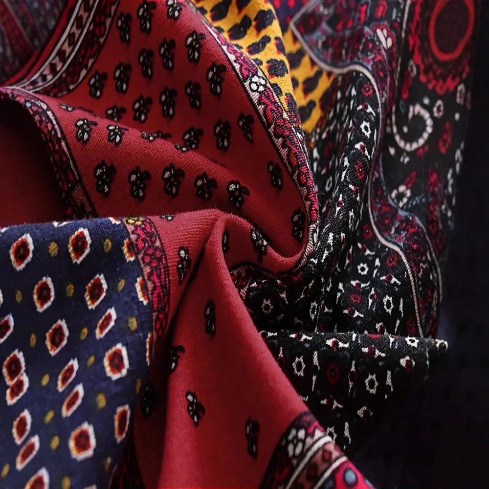 Close-up of colorful patterned fabric with red, black, blue, and yellow intricate designs