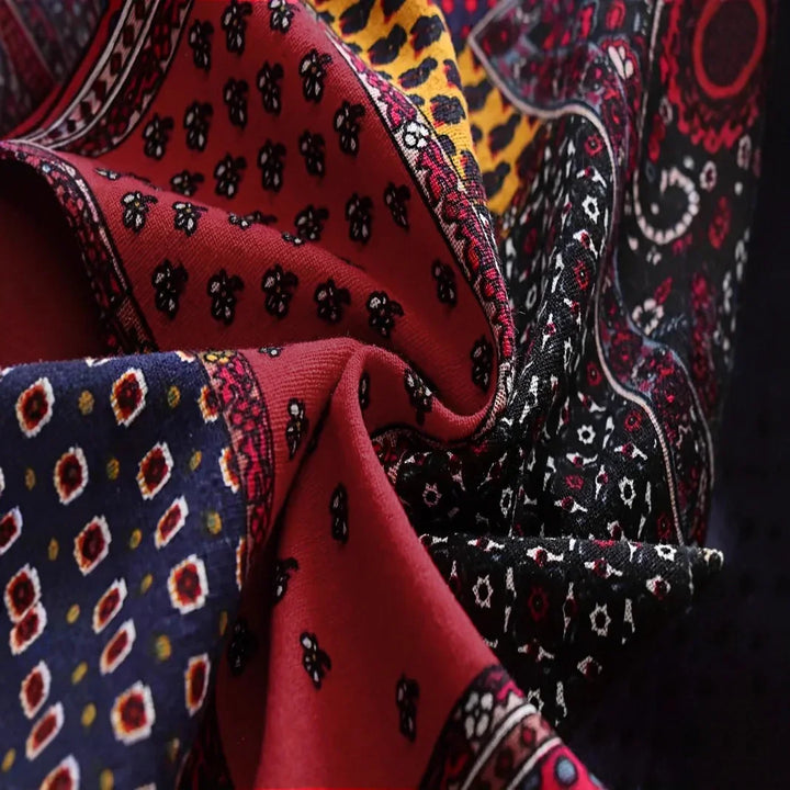 Close-up of colorful patterned fabric with red, black, blue, and yellow intricate designs