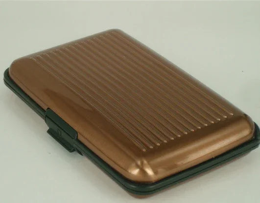 Compact brown hard-shell card holder with black edges and ribbed design