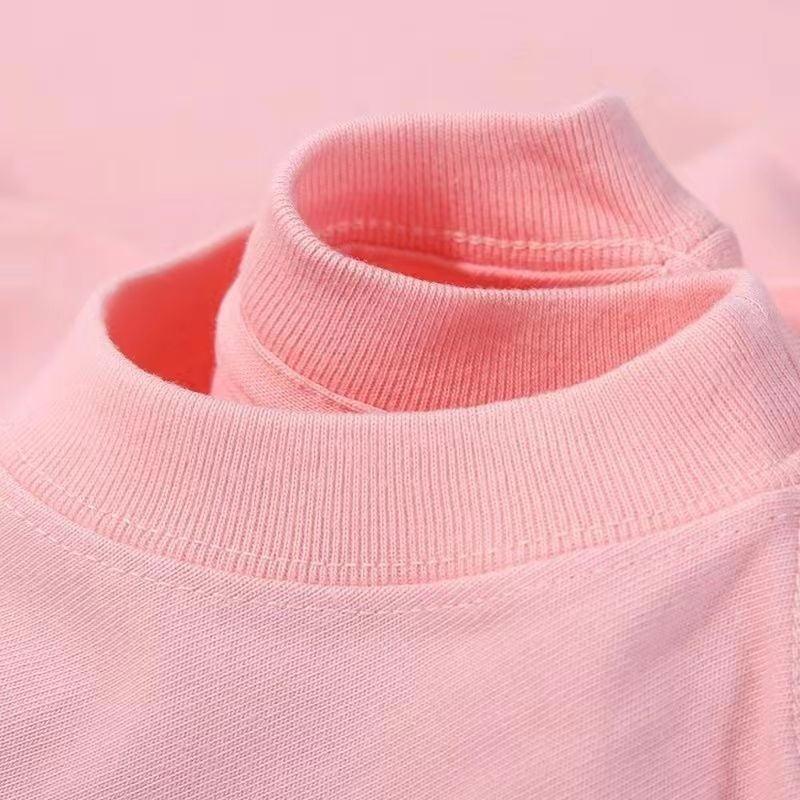 Close-up of pink ribbed turtleneck sweater collar made of soft knit fabric
