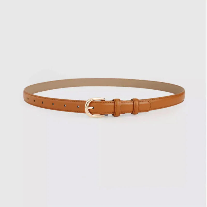 Slim tan leather belt with gold buckle and multiple adjustment holes on white background