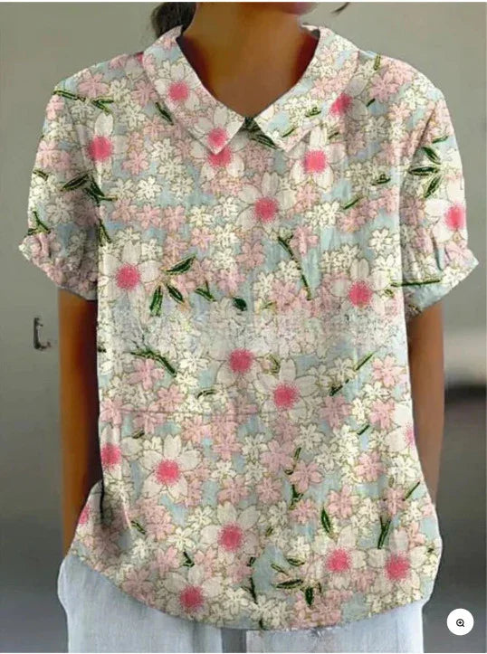 Woman wearing pastel floral print short sleeve blouse with collar and front buttons