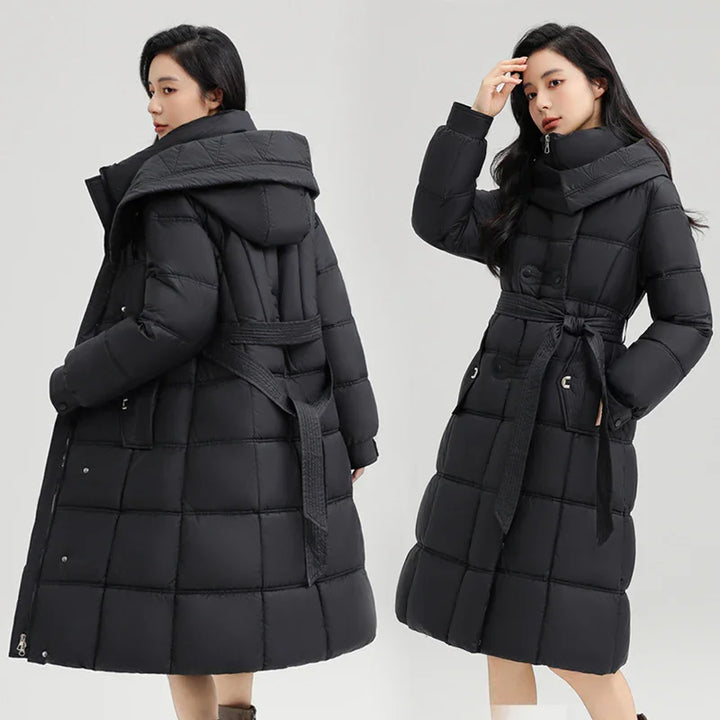Woman wearing long black quilted puffer coat with hood and belt posing front and back