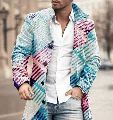 Man wearing colorful patterned coat over white shirt and jeans in urban outdoor setting