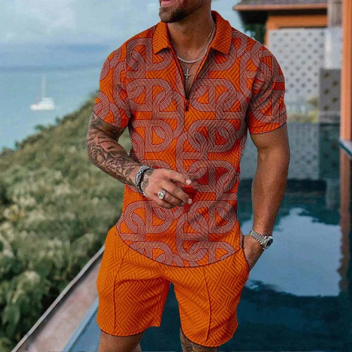 Man wearing stylish orange geometric patterned short sleeve shirt and matching shorts by poolside with greenery background