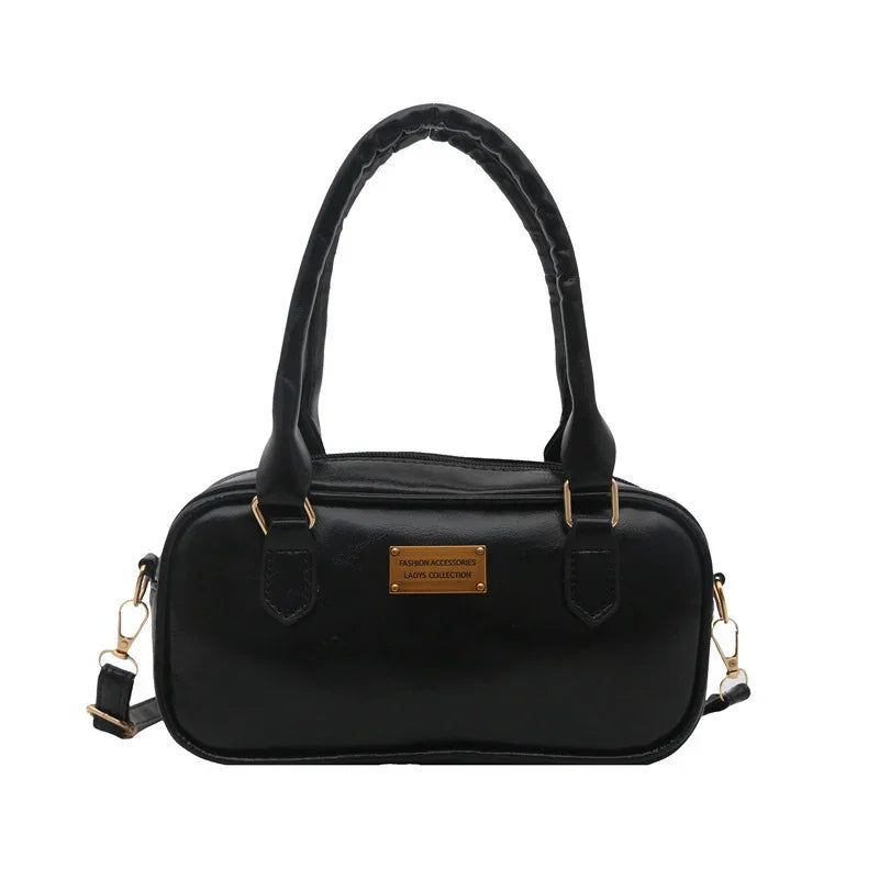 Black leather ladies handbag with double handles and gold hardware, rectangular shape purse