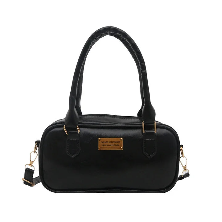 Black leather ladies handbag with double handles and gold hardware, rectangular shape purse
