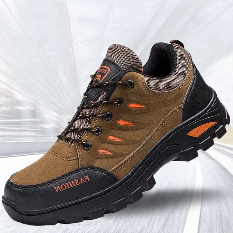 Brown and black outdoor hiking shoe with orange accents and durable sole on blurred background