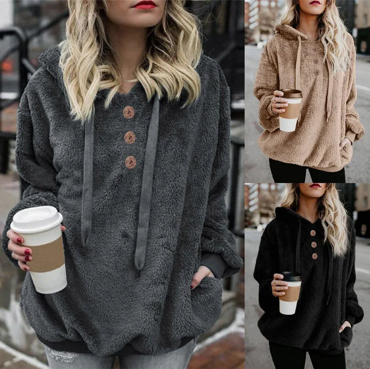 Women wearing cozy sherpa hoodies in gray, beige, and black styles holding coffee cups outdoors
