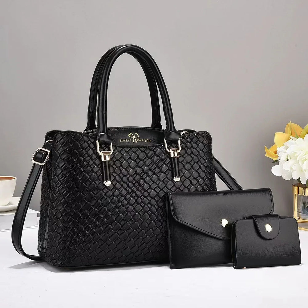 Black woven leather handbag with matching wallet and cardholder on white surface