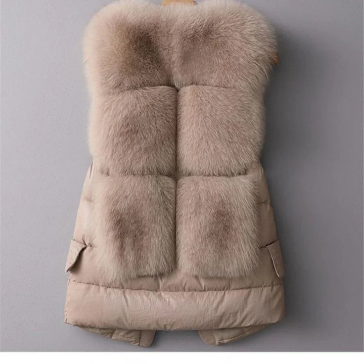 Beige padded winter vest with large fluffy fur panels and side pockets on gray background