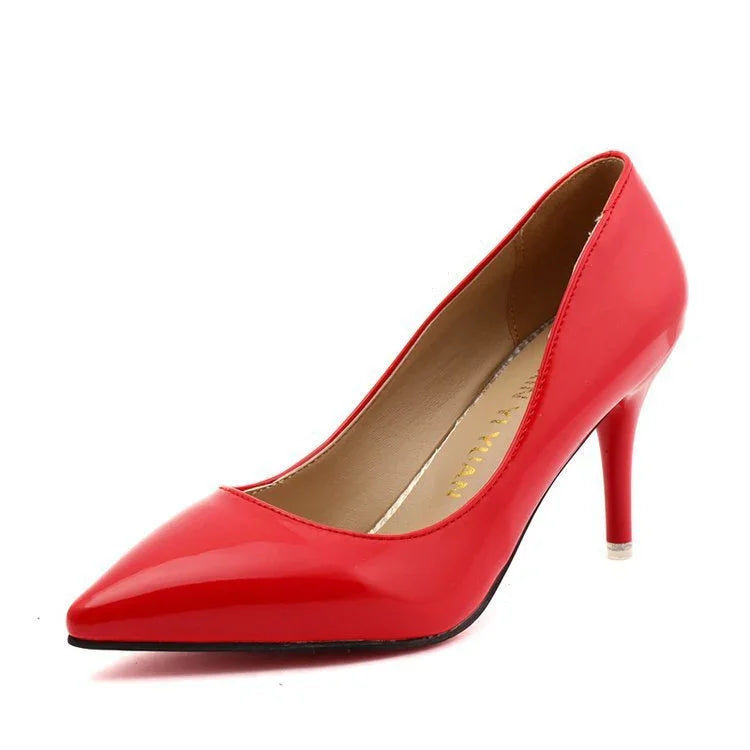 Shiny red patent leather high heel pump with pointed toe on white background