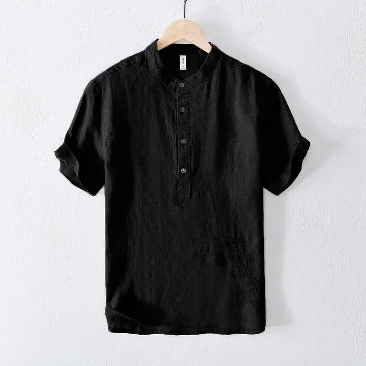 Black short-sleeve henley shirt with mandarin collar hanging on wooden hanger
