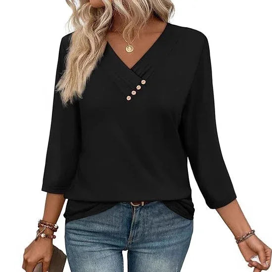 Woman wearing black V-neck blouse with three buttons and 3/4 sleeves paired with blue jeans