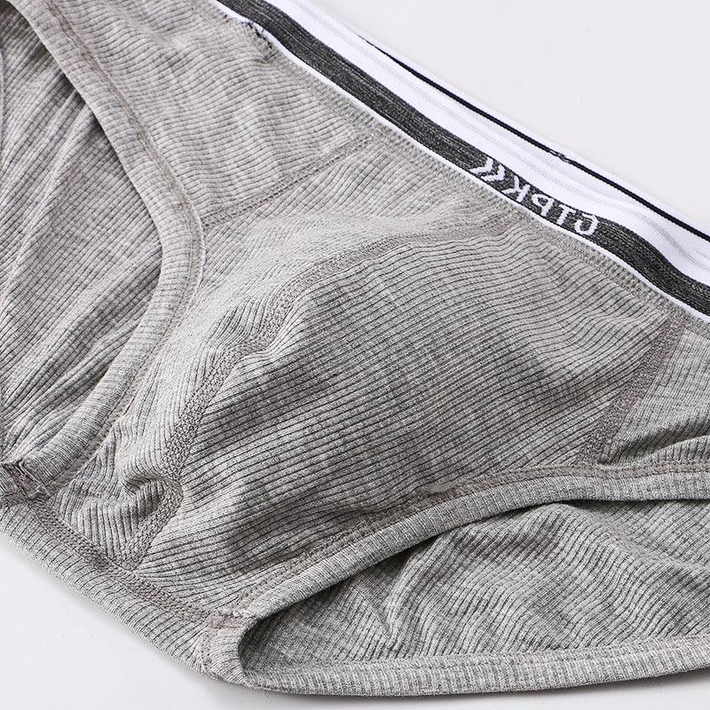 Close-up of grey ribbed men's briefs with branded elastic waistband on white background