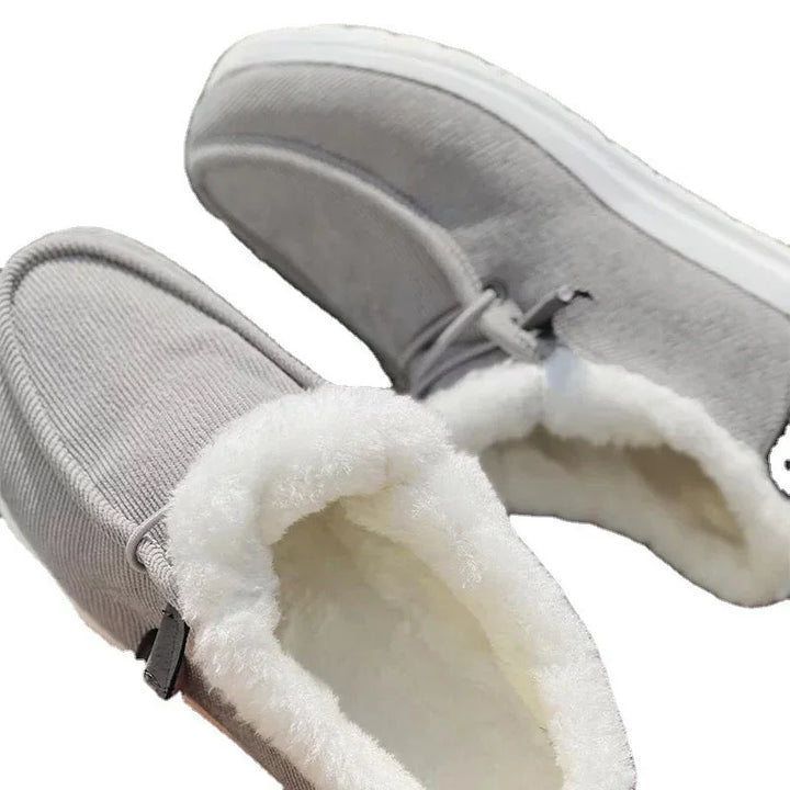 Gray moccasin slippers with soft white fleece lining and rubber soles for indoor comfort