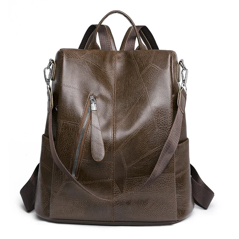 brown leather backpack with front zipper pocket and adjustable straps on white background