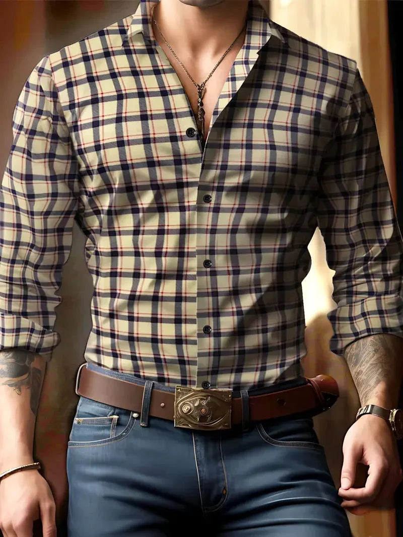 Man wearing beige and navy plaid shirt with rolled sleeves, brown belt, and dark jeans