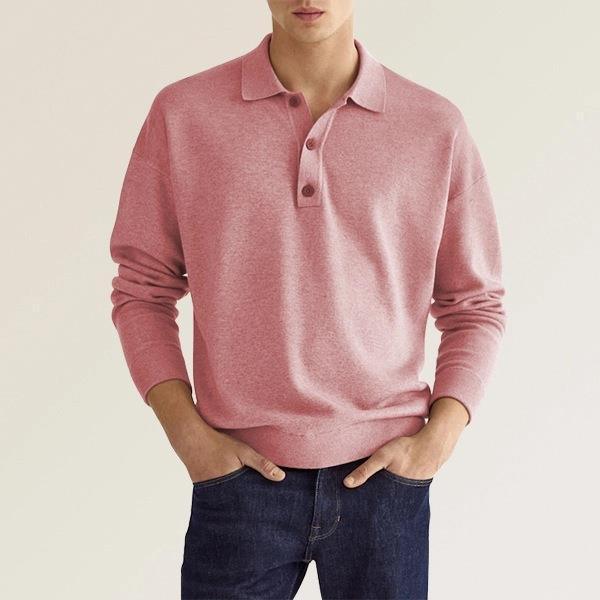 man wearing a pink long-sleeve polo shirt with buttons paired with dark blue jeans