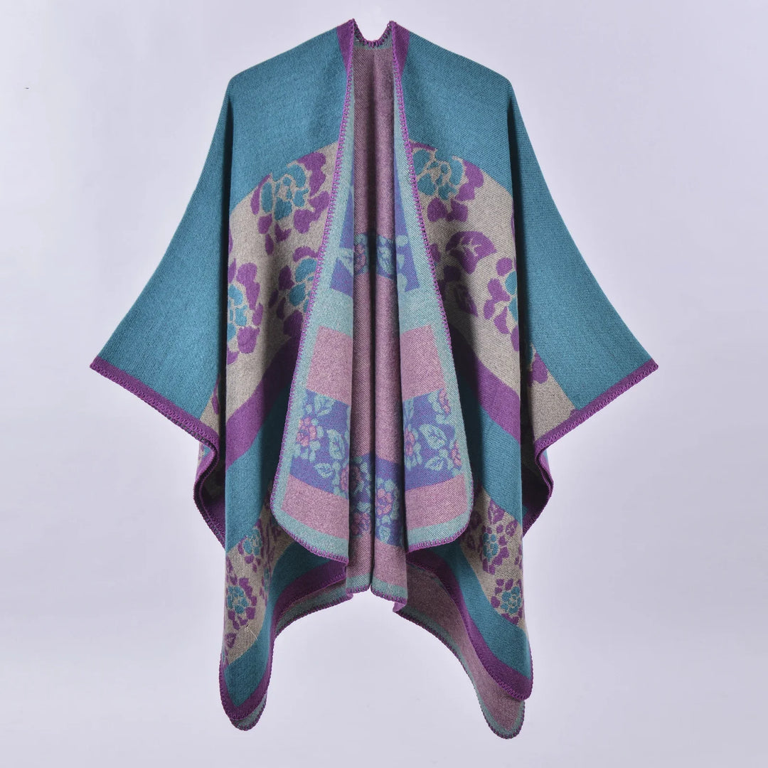 Colorful wool poncho with blue, purple, and beige floral patterns and purple trim