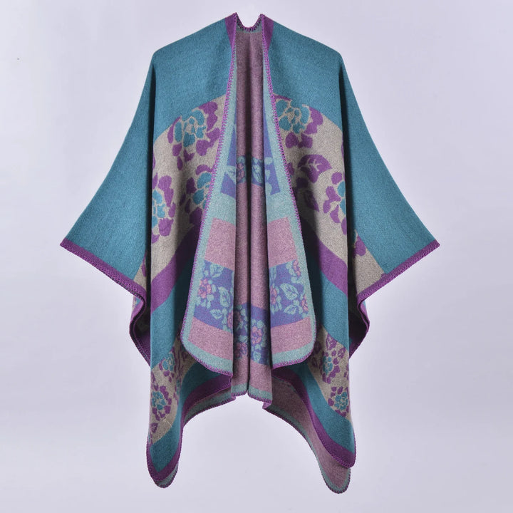Colorful wool poncho with blue, purple, and beige floral patterns and purple trim