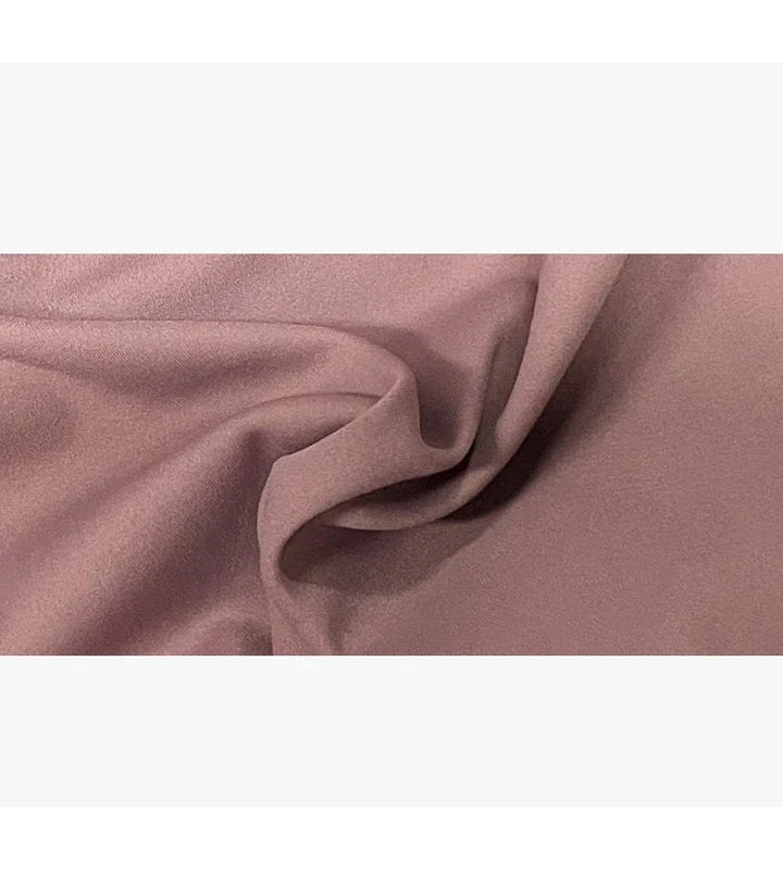 close-up of soft mauve fabric with smooth texture and gentle folds