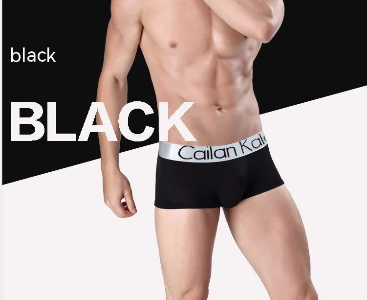 Male model wearing black boxer briefs with white waistband labeled Cailan Kair against black and white background