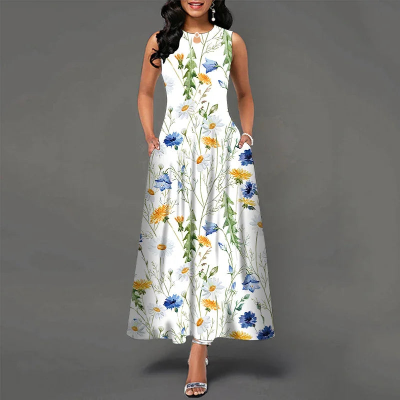 Woman wearing sleeveless white maxi dress with colorful floral print, standing against gray background