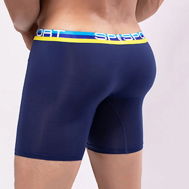 Back view of man wearing navy blue sports boxer briefs with blue and yellow waistband