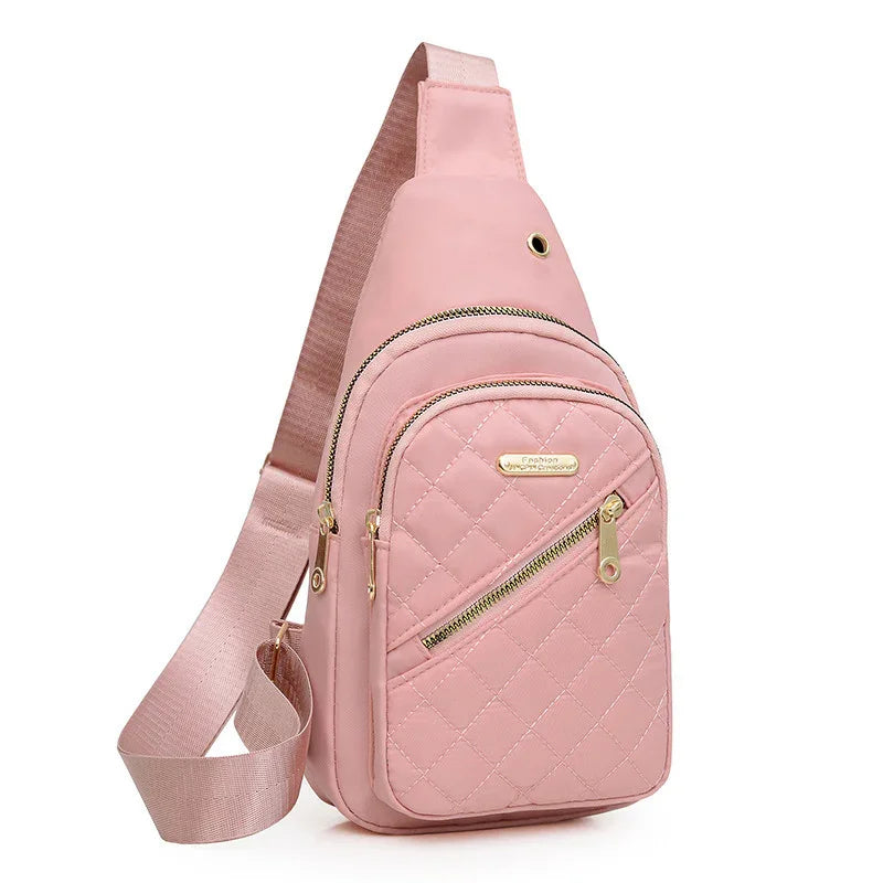 Pink quilted crossbody sling bag with gold zippers and adjustable strap