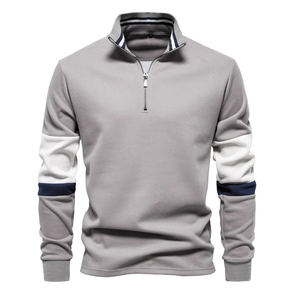 Men's grey quarter-zip pullover with white and navy color block sleeves and striped collar