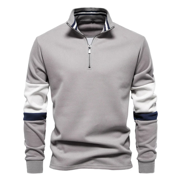 Men's grey quarter-zip pullover with white and navy color block sleeves and striped collar