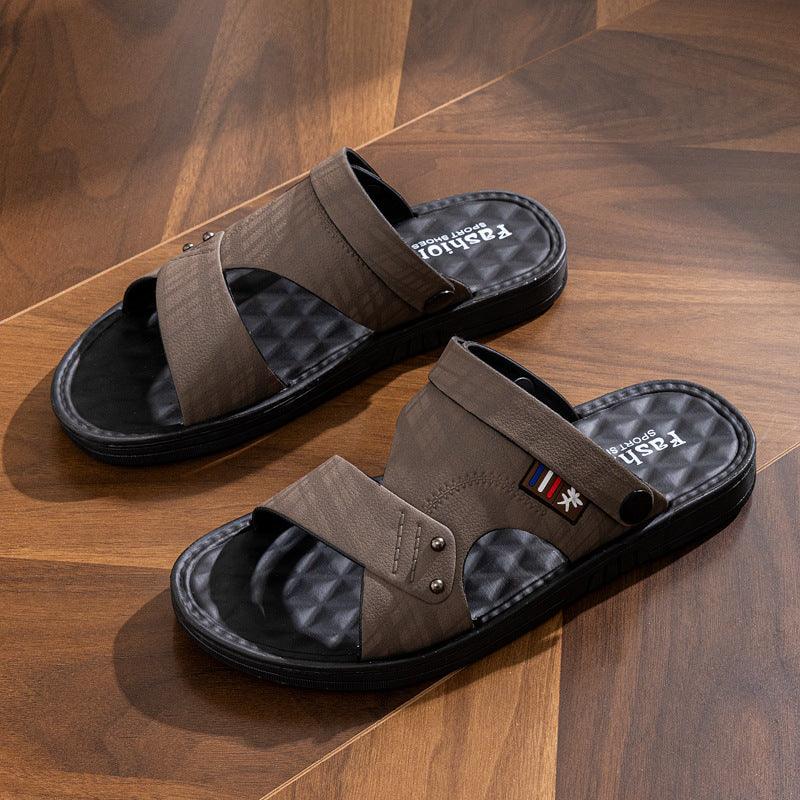Brown sport sandals with black cushioned soles on wooden floor, featuring adjustable straps