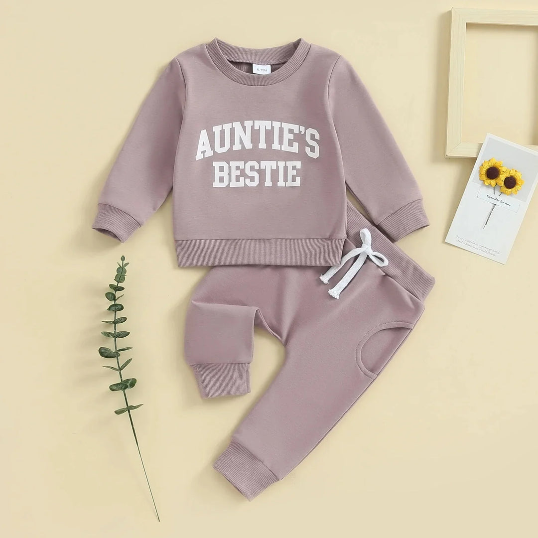 Mauve baby toddler outfit with white 'Auntie's Bestie' slogan, matching pants, and decorative plants