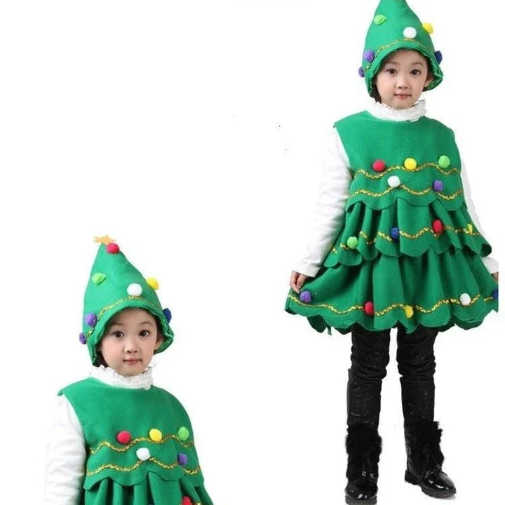 Child wearing green Christmas tree costume with colorful pom pom decorations and matching hat