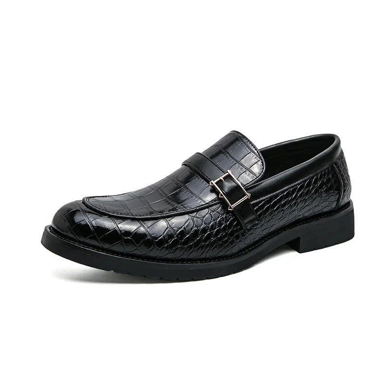 Black men's dress loafer with crocodile texture and decorative buckle on white background