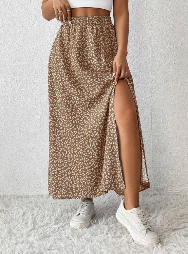 woman wearing brown floral slit maxi skirt with elastic waistband and white sneakers on shaggy white rug