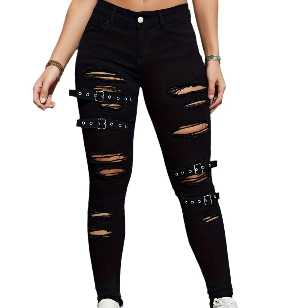 Woman wearing black ripped skinny jeans with buckle strap accents and white sneakers