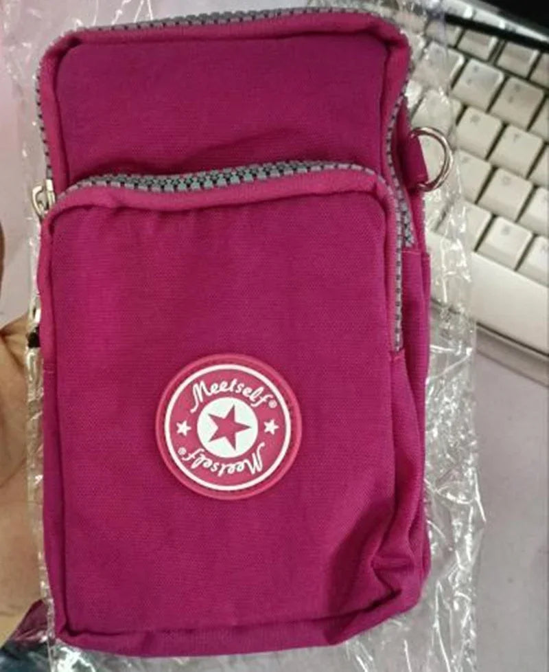 Pink compact shoulder bag with front zipper pocket and round Meetselff logo patch