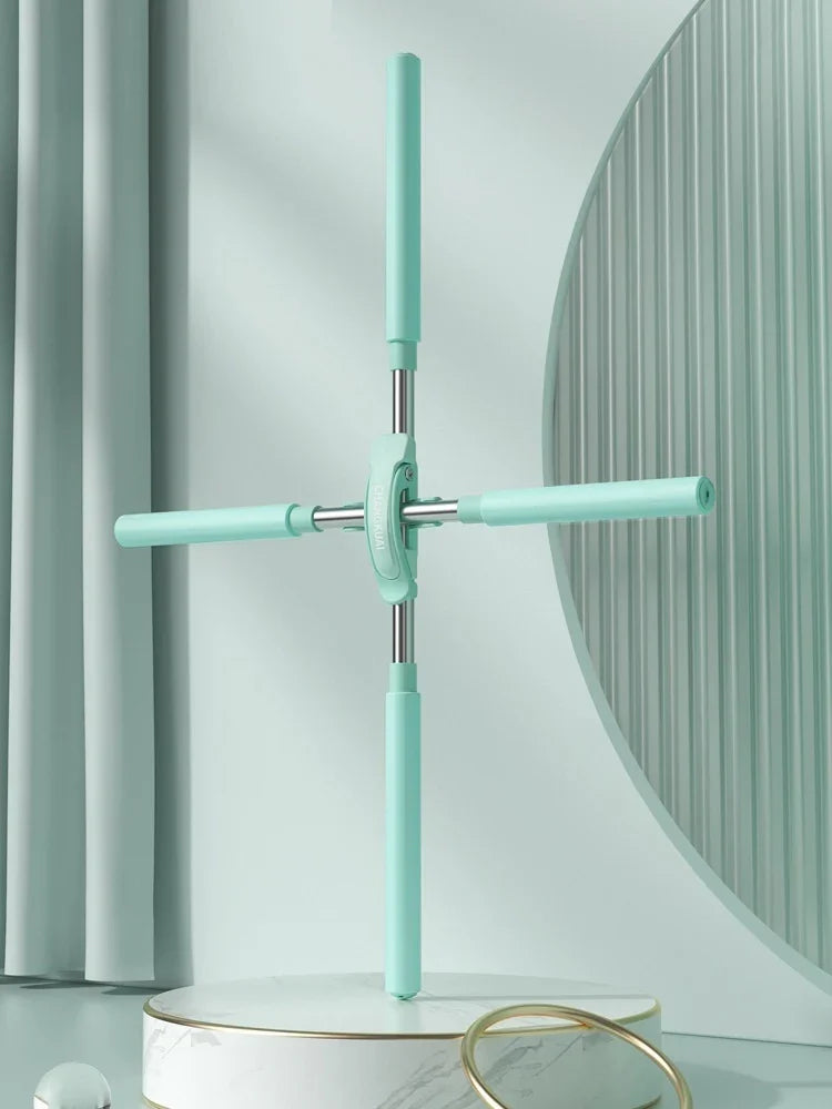 Mint green foldable floor mop with four arms on a marble platform, minimal background