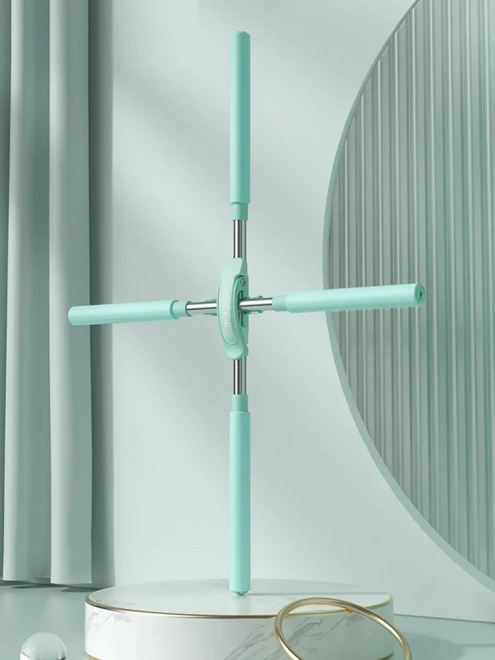 Mint green foldable floor mop with four arms on a marble platform, minimal background