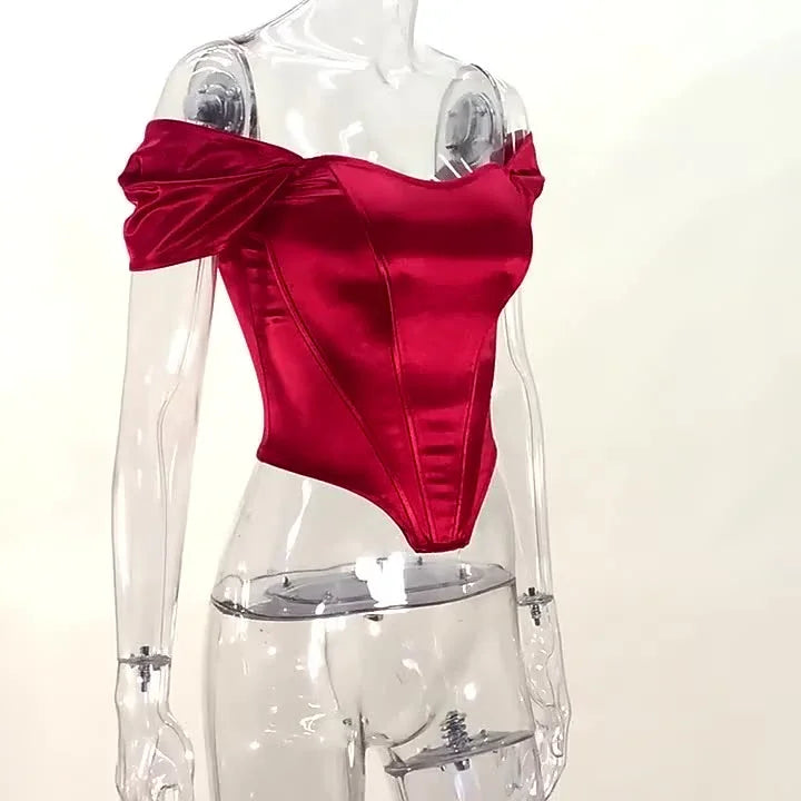 Red satin off-shoulder corset top displayed on a clear mannequin against white background