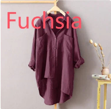 Fuchsia oversized button-up shirt dress hanging on wooden hanger against gray wall