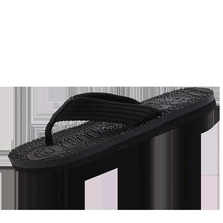 black cushioned flip flop sandal with textured sole and fabric strap