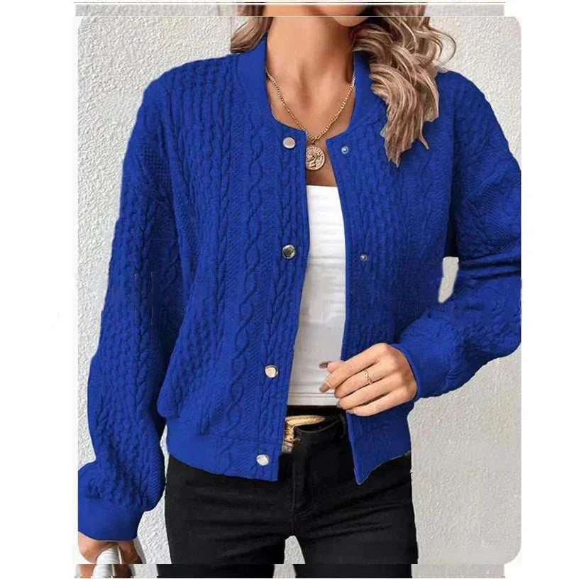 woman wearing royal blue cable knit button-up cardigan with white top and black pants