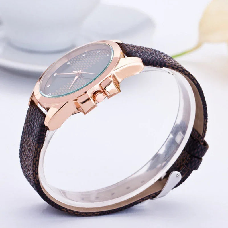 Elegant wristwatch with rose gold case and textured dark brown leather strap on white background