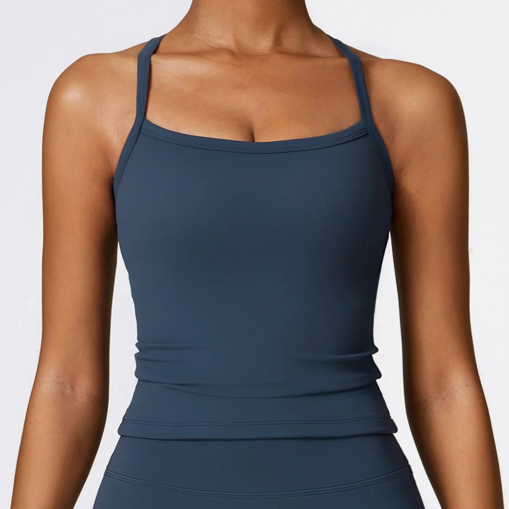 Close-up of woman wearing navy blue fitted tank top with thin straps