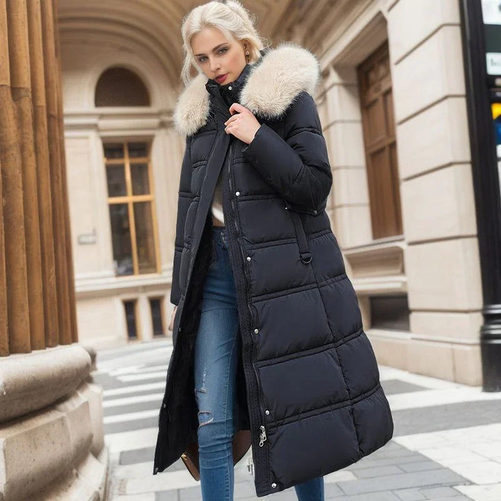 Blonde woman wearing long black puffer coat with fur collar and ripped blue jeans outdoors