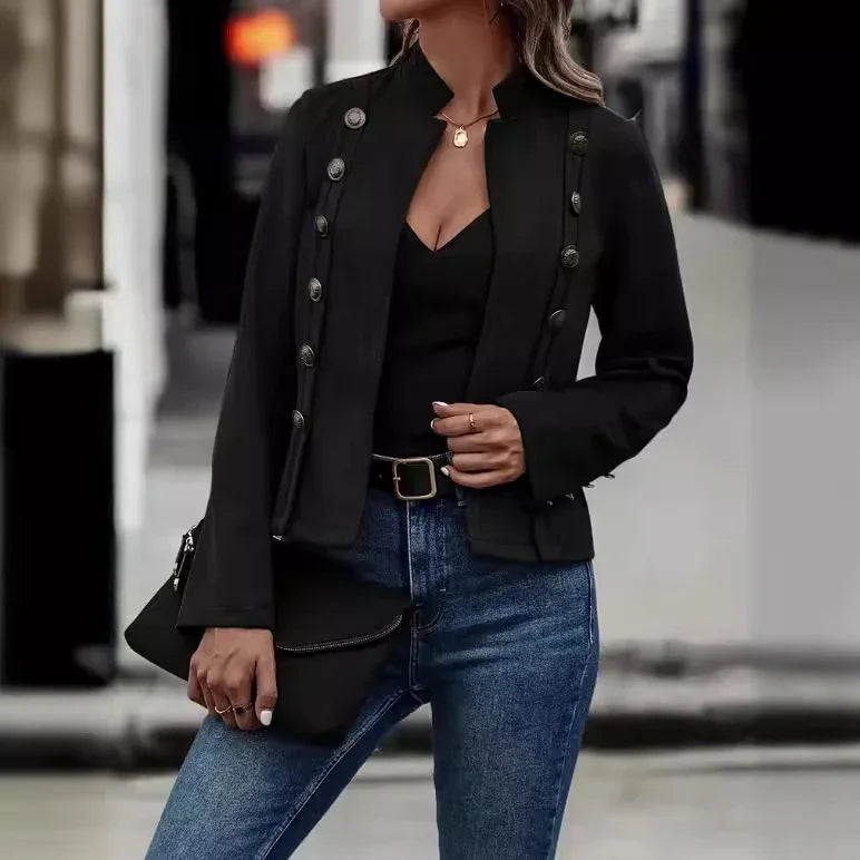 Woman wearing stylish black buttoned blazer, black top, blue jeans, holding black clutch bag